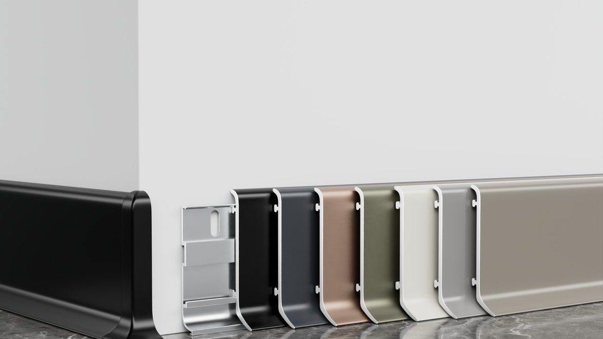 Aluminum baseboards in six finishes standing by a wall